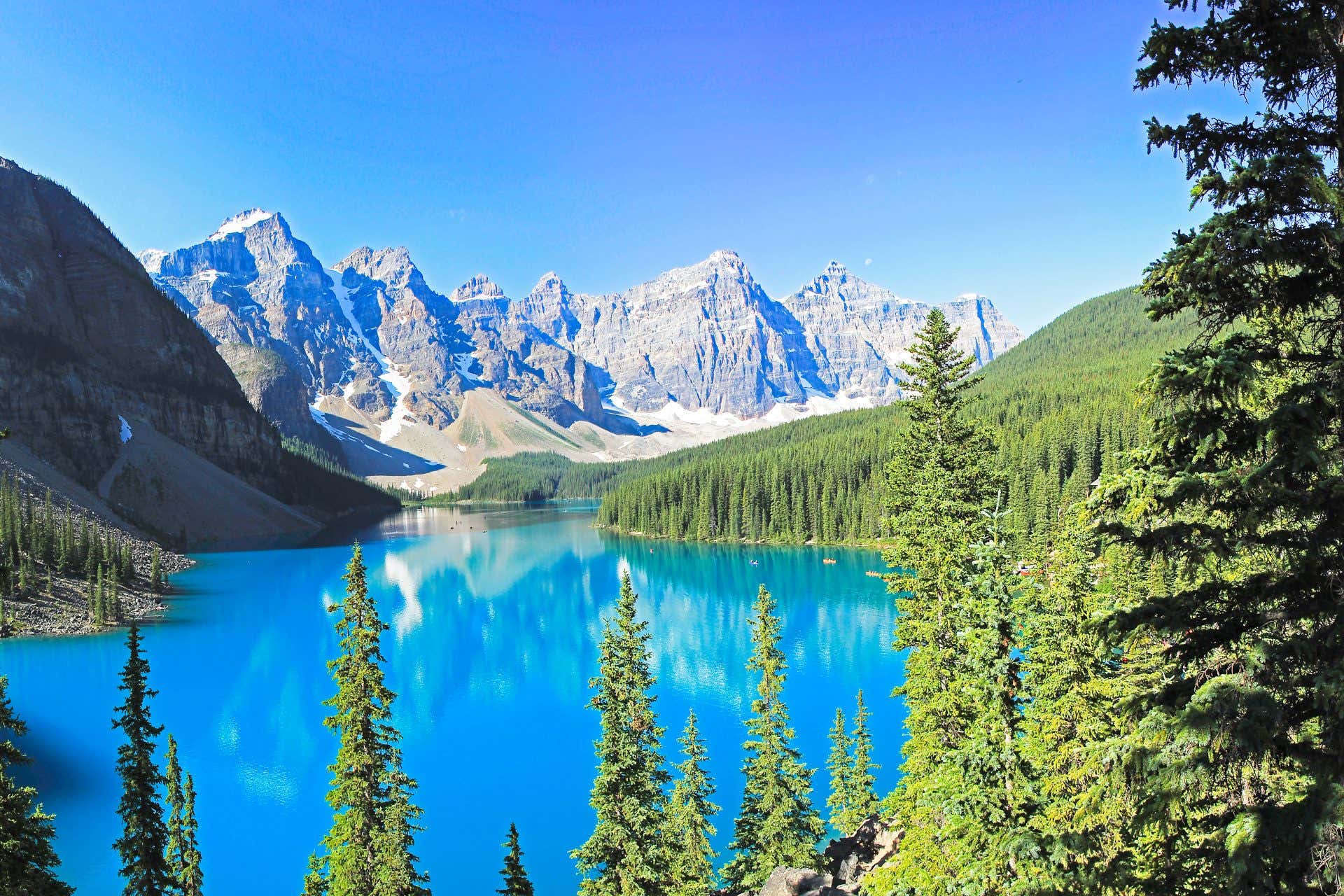 Moraine lake, Alberta, CANADA - July 14, 2017: Moraine Lake in the sun, beautiful blue water, rocky mountains in the back