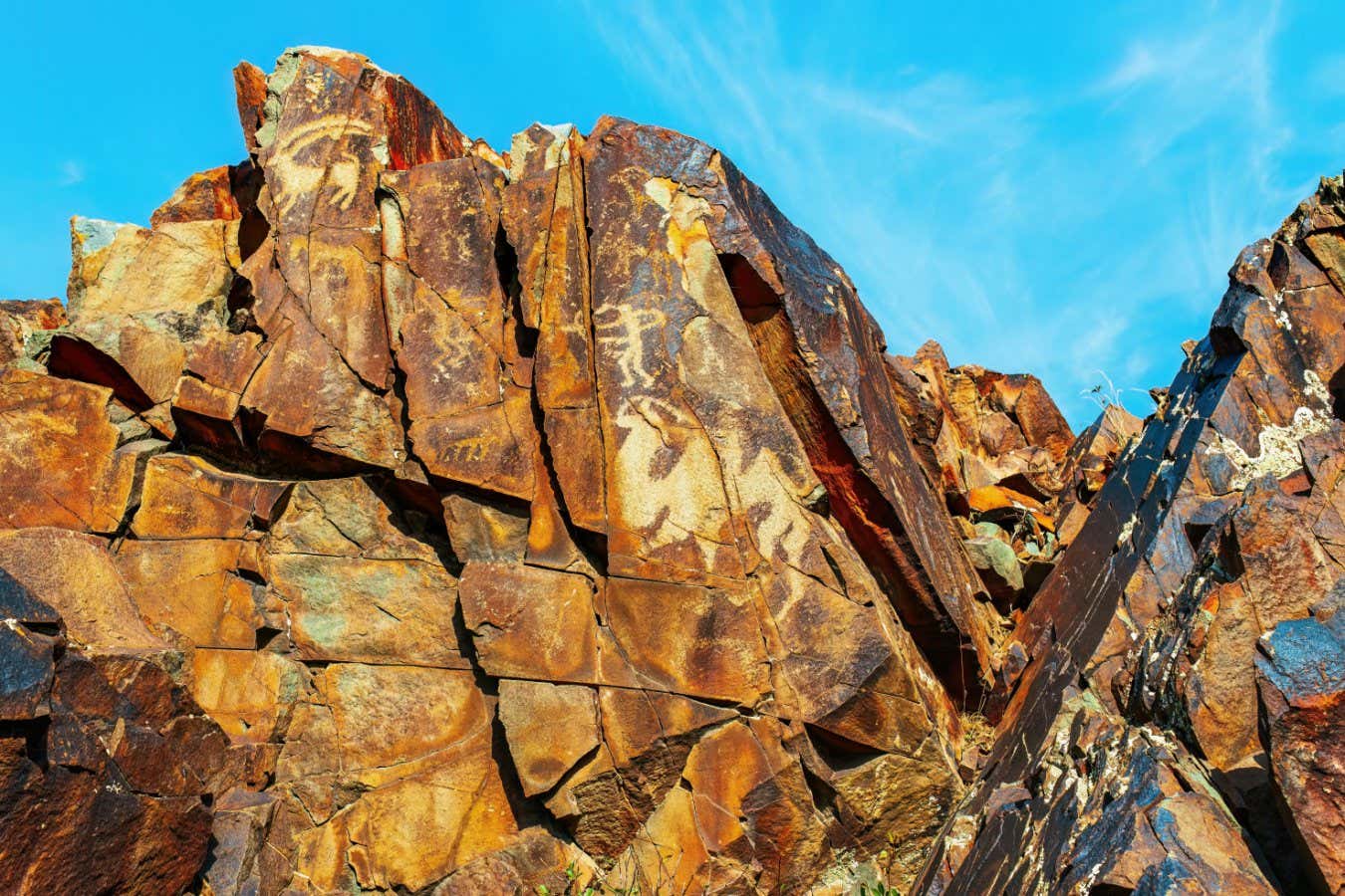 Ancient cave paintings on rocks in Karasay gorge, Taraz, Zhambyl Region, Kazakhstan. Petroglyphs Bronze Age and Iron Age rock art; Shutterstock ID 2465182461; purchase_order: -; job: -; client: -; other: -