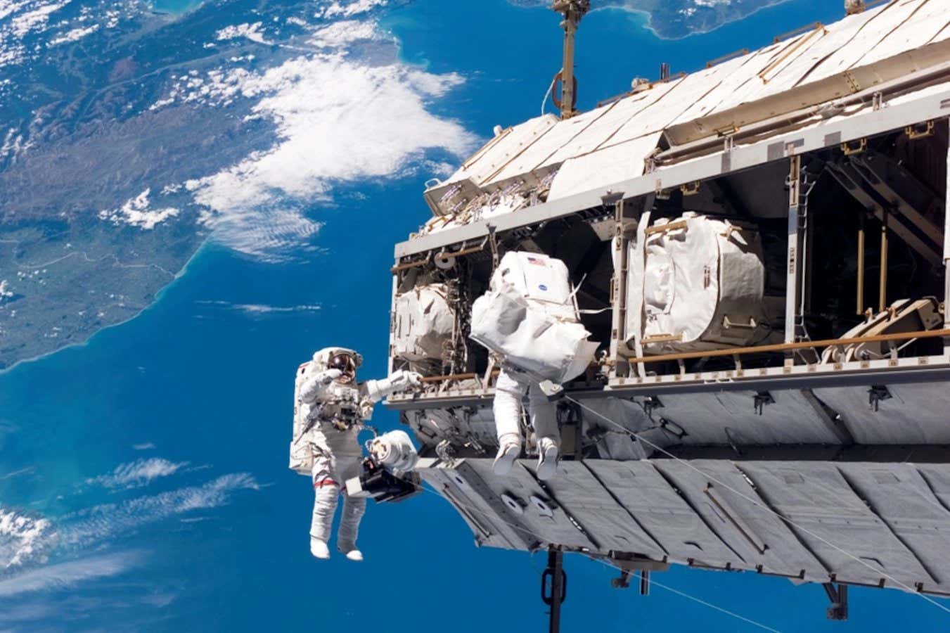 Astronauts Robert L. Curbeam Jr. (left) and Christer Fuglesang on the International Space Station